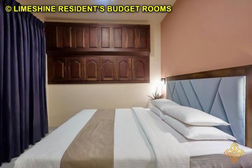 a bedroom with a bed with white sheets and pillows at Limeshine - Airport Transit Hotels & Residences in Katunayake