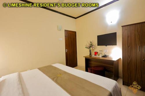 a bedroom with a bed and a desk and a television at Limeshine - Airport Transit Hotels & Residences in Katunayake