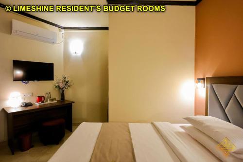 a bedroom with a bed and a desk and a television at Limeshine - Airport Transit Hotels & Residences in Katunayake
