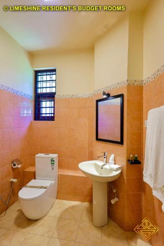 a bathroom with a toilet and a sink at Limeshine - Airport Transit Hotels & Residences in Katunayake