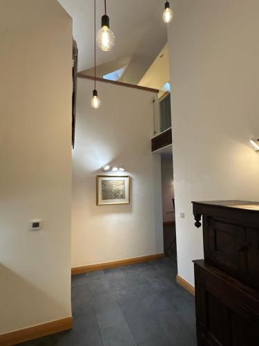 a room with a hallway with a wall with lights at Lower Carhullan in Penrith