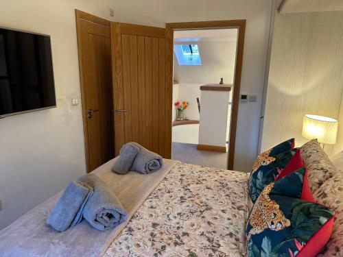 a bedroom with a bed with towels on it at Lower Carhullan in Penrith