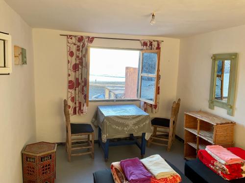 a room with a table and a window at Aftas Beach Studio in Mirleft