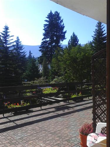 a patio with flowers in pots on a fence at Willa Grafit in Karpacz