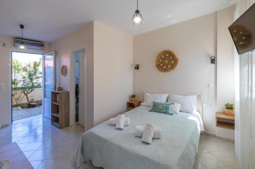 a bedroom with a bed with towels on it at Alex Downtown Studio in Argostoli