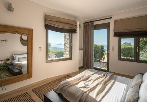 a bedroom with a bed and a large mirror at Villa Matelia Chalkidiki in Neos Marmaras