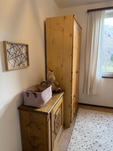 a room with a wooden cabinet and a teddy bear at Casa Sonia Your Refuge in Valle Verzasca in Frasco