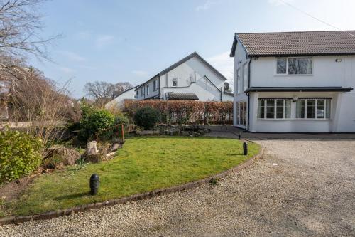 a house with a yard in front of it at Robins Perch, Bramhall in Bramhall