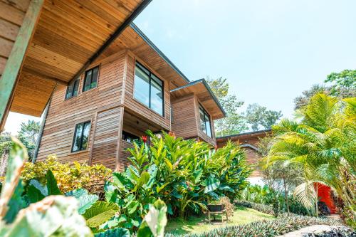 a wooden house with plants in front of it at MALU Cabins in Bocas del Toro