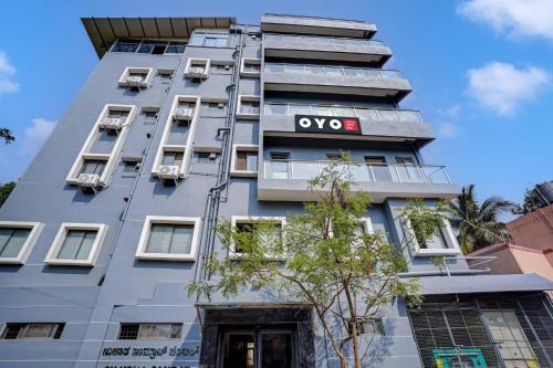 an apartment building with an ovo sign on it at Hotel O METRO VIEW INN in Bengaluru