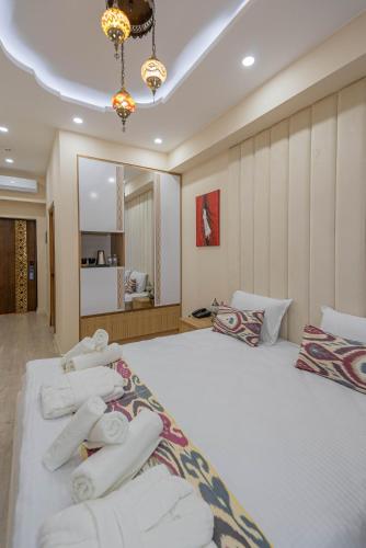 a bedroom with a large bed with towels on it at Volidam Hotel in Samarkand