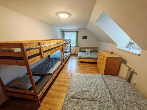 a room with two bunk beds in a attic at Chalupa Širůček Budislav in Budislav