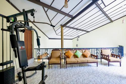 a room with a gym with chairs and a treadmill at Limeshine - Airport Transit Hotels & Residences in Katunayake