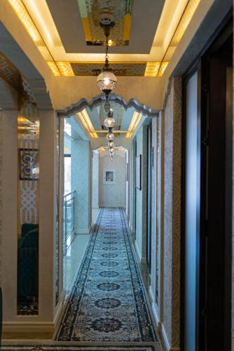 a hallway in a building with a rug on the floor at Volidam Hotel in Samarkand