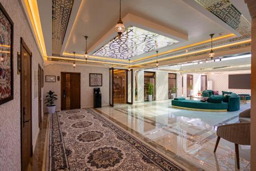 a large living room with a blue couch in a room at Volidam Hotel in Samarkand