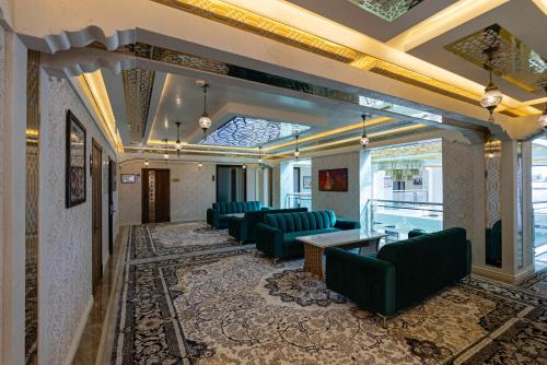 a waiting room with blue chairs and a table at Volidam Hotel in Samarkand