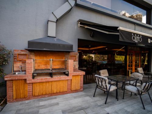 a outdoor grill with a table and chairs in front of a restaurant at Swissotel Quito in Quito