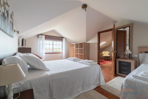 a bedroom with a large white bed in a room at Casa de Pili - by entreRías in Cangas de Morrazo