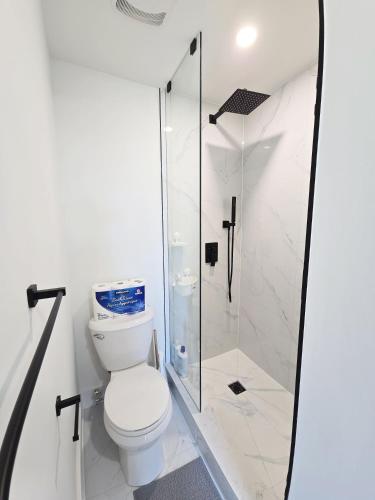 a bathroom with a toilet and a glass shower at Modern Private Room Private Bathroom with King Bed with TV and Optional Balcony 10 minutes to Rogers Stadium Midtown Downtown Toronto in Toronto