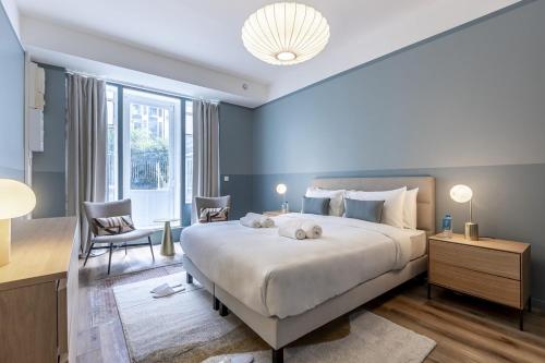 une chambre avec un grand lit et une grande fenêtre dans l'établissement Opera # Louvre # PalaisRoyal # Académiefrançaise # AC, à Paris