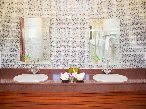 a bathroom with two sinks and two mirrors at Dork Bua Villa in Bophut