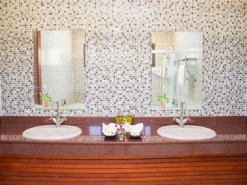 a bathroom with two sinks and two mirrors at Dork Bua Villa in Bophut 