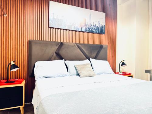 a bedroom with a large white bed and orange stripes at Ica Adventures II in Ica
