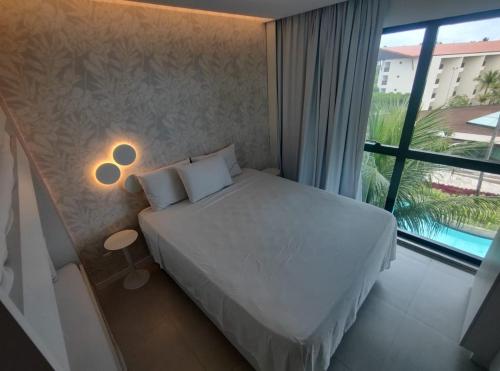 Giường trong phòng chung tại Marulhos Resort vista Piscina flat Premium