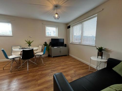 a living room with a couch and a table at Three Bedroom Townhouse with Parking in Telford