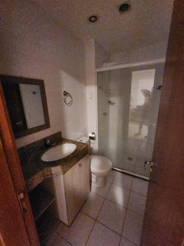 a bathroom with a toilet and a sink and a shower at 4º Città Residence - Piscina e academia in Brasília