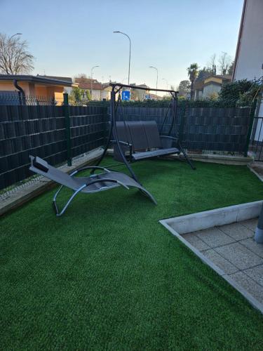 a yard with a swing set on the grass at la casa di ida superior in Vigevano