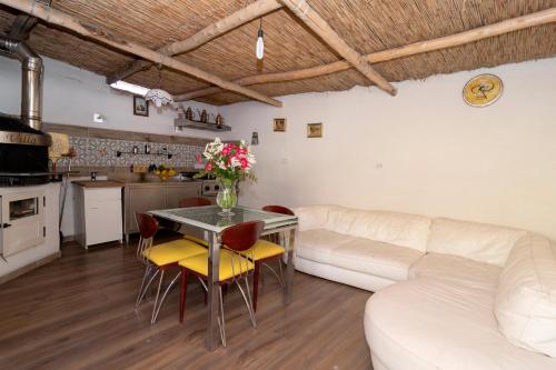 a living room with a white couch and a table at Villa Caruso in Massa Lubrense