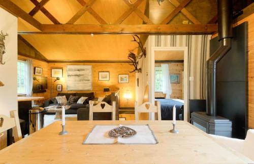 - un salon avec une table et deux bougies dans l'établissement Authentic mountain cabin with river at 900m lake, à Xonrupt-Longemer