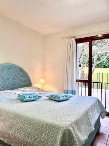 a bedroom with a bed and a window at Over The Sea Punta Lada in Porto Rotondo