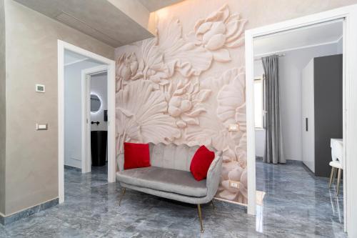 a living room with a couch and a pink wall at Villa Caruso in Massa Lubrense