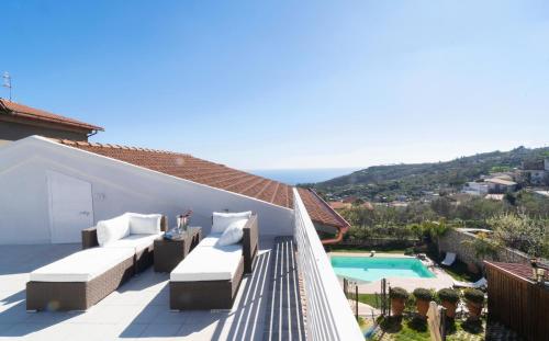 a balcony of a house with a swimming pool at Villa Caruso in Massa Lubrense