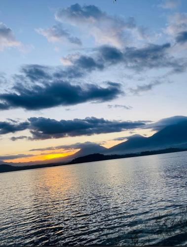 a sunset over a large body of water at Ruhondo Beach Resort in Ruhengeri