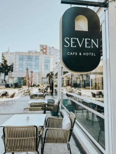 a cafe and hotel sign on the side of a building at Seven cafe & hotel in Pogradec