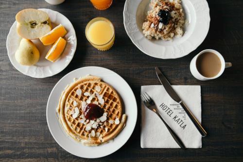 a table topped with plates of breakfast foods and drinks at Hotel Katla by Keahotels in Vík