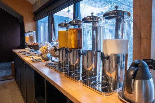 a counter with a bunch of silver tanks on it at Hotel Katla by Keahotels in Vík