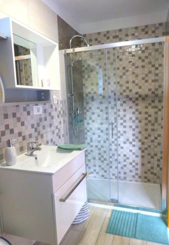 a bathroom with a sink and a shower at HišaŠmihelka in Kobarid