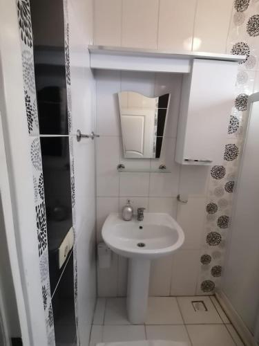 a white bathroom with a sink and a mirror at Villa angel in Sarigerme