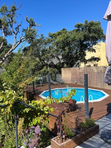 a swimming pool in a yard with a garden at Casa Alana in Mira