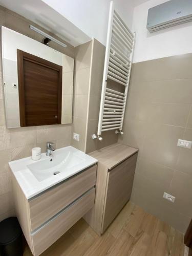 a bathroom with a sink and a mirror at Largo Zeza Quindici in Boiano