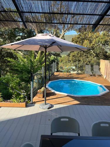 a large umbrella sitting next to a swimming pool at Casa Alana in Mira