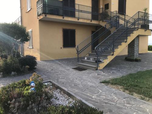 a building with a staircase and a fire hydrant in a yard at Casamia Appartament in Marzocca di Senigallia