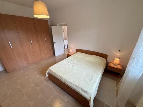 a bedroom with a bed and two night stands at Casamia Appartament in Marzocca di Senigallia