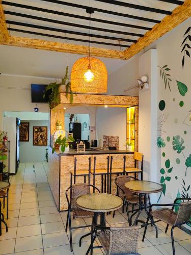 a restaurant with tables and chairs and a kitchen at Tengana Hospedaje y Tours in Tarapoto