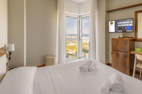 a hotel room with a bed and a window at B&B Hotel Chioggia Airone in Sottomarina