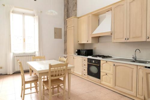 a kitchen with a table and a table and chairs at Pisa Paradiso Nice View in Pisa